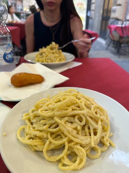 Traditional Roman cacio e pepe pasta served at a local restaurant