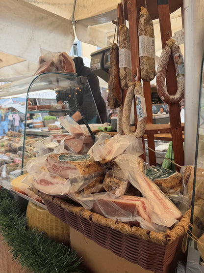 Traditional Italian cured meats at a Roman food market