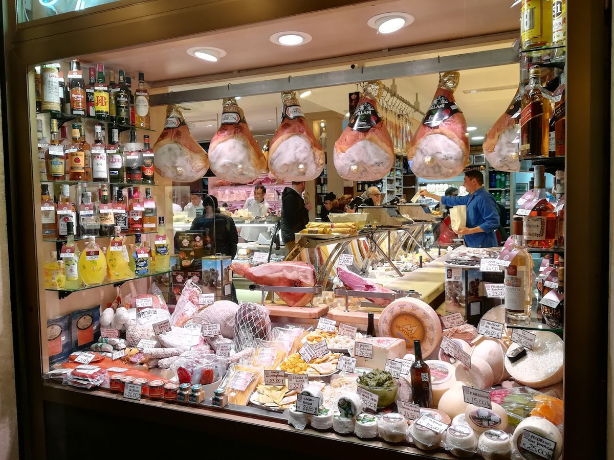 Roman cured meats and Italian cheeses at a traditional food shop in Rome