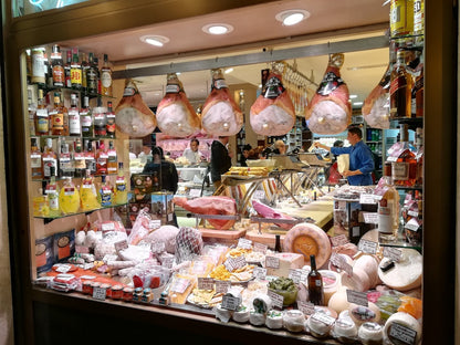 Roman cured meats and Italian cheeses at a traditional food shop in Rome