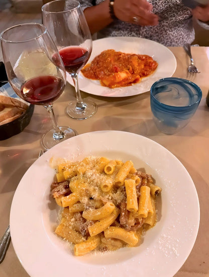 Traditional Roman pasta served with wine in Rome