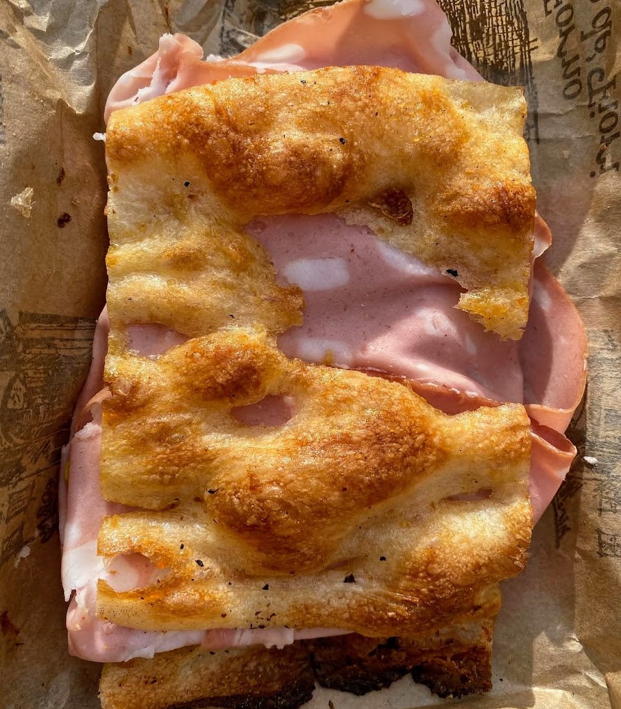 Crispy Roman supplì with melted cheese, a classic Roman street food