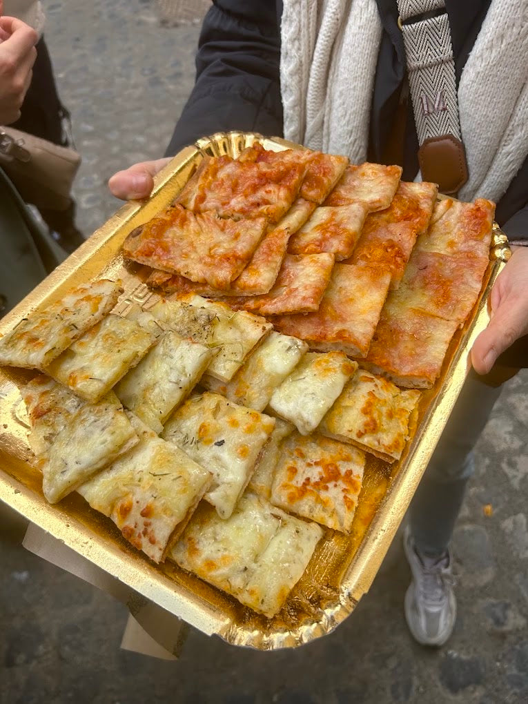 Roman pizza al taglio enjoyed during a Rome food tour