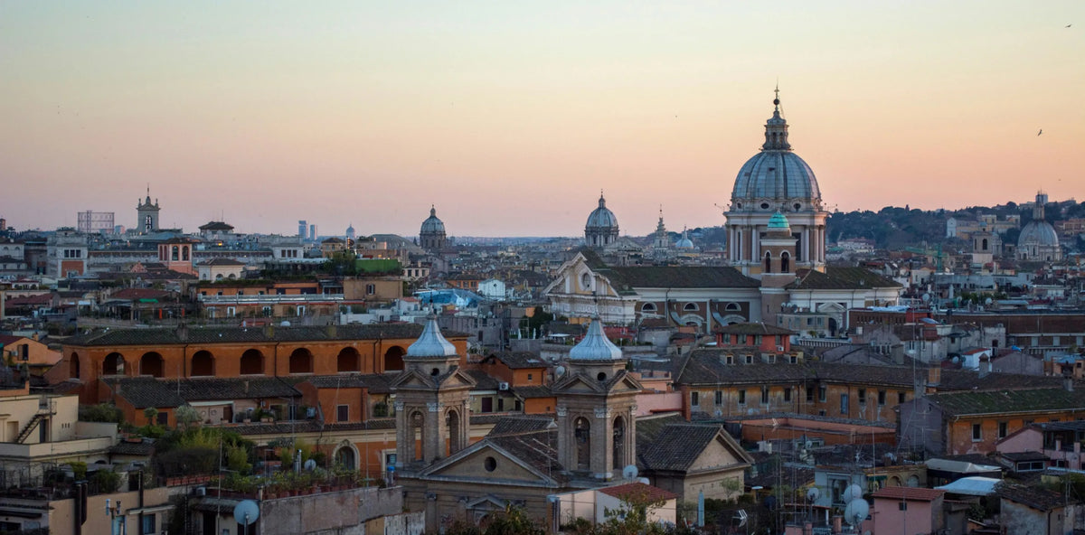 Panoramic view of Rome with historic domes at sunset