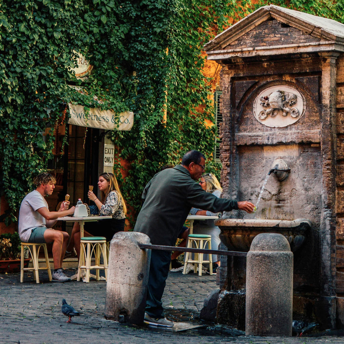 Local life in Rome with a historic fountain and outdoor café