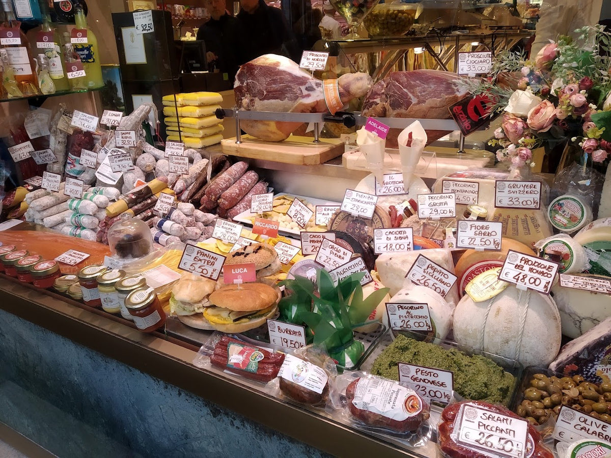 Italian cheeses and cured meats at a food market in Rome